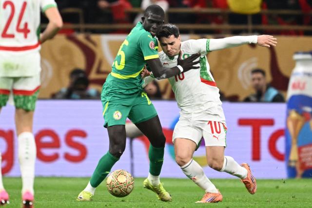 Senegal's defender #25 El Hadji Malick Diouf and Morocco's forward #10 Brahim Diaz vie during the Africa Cup of Nations (CAN) final football match between Senegal and Morocco at the Prince Moulay Abdellah Stadium in Rabat on January 18, 2026. (Photo by SEBASTIEN BOZON / AFP)