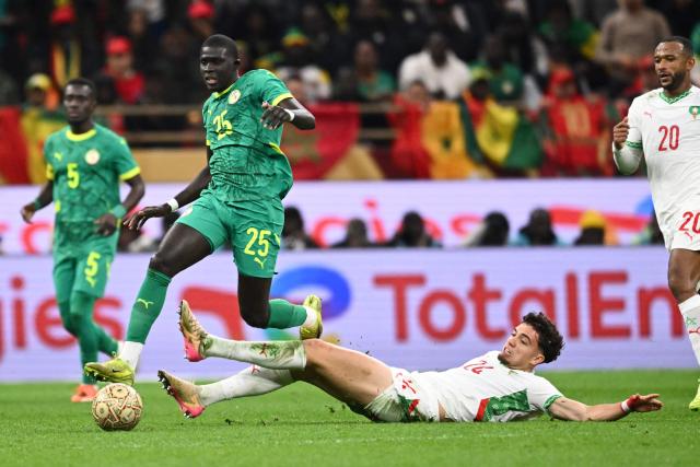 Senegal's defender #25 El Hadji Malick Diouf and Morocco's midfielder #24 Neil El Aynaoui vie during the Africa Cup of Nations (CAN) final football match between Senegal and Morocco at the Prince Moulay Abdellah Stadium in Rabat on January 18, 2026. (Photo by SEBASTIEN BOZON / AFP)