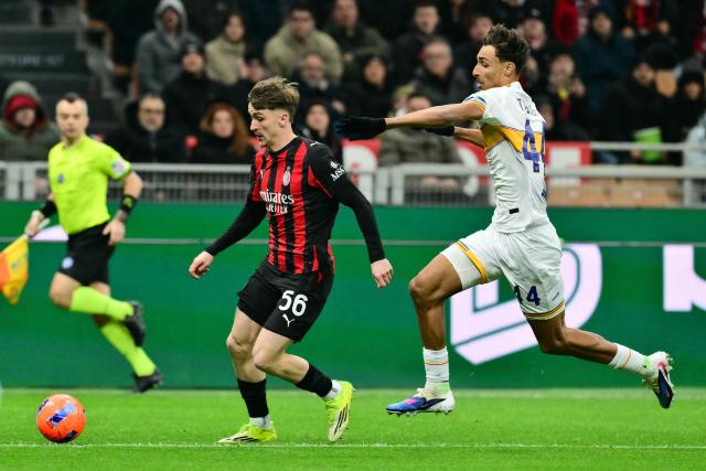 AC Milan's Belgian midfielder #56 Alexis Saelemaekers fights for the ball with Lecce's Portuguese defender #44 Tiago Gabriel during the Italian Serie A football match between AC Milan and Lecce at San Siro stadium in Milan, northern Italy, on January 18, 2026. (Photo by Stefano RELLANDINI / AFP)