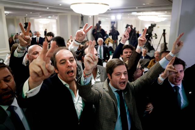 Supporters of far-right candidate Andre Ventura, leader of Chega party, react to the exit poll results on the night of Portugal's presidential election first round in Lisbon on January 18, 2026. Portugal voted today in the first round of a presidential election in which a far-right candidate is expected it get to the run-off for the first time. The role of president is largely ceremonial but in times of crisis the incumbent can dissolve parliament, call elections or dismiss a prime minister. (Photo by FILIPE AMORIM / AFP)