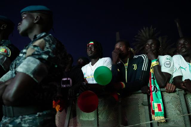 TOPSHOT - Senegal football supporters react at the Obelisk Square in Dakar on January 18, 2026 as supporters gather at a fan zone to watch the Africa Cup of Nations (CAN) final football match between Senegal and Morocco played in Rabat, Morocco. (Photo by SEYLLOU / AFP)