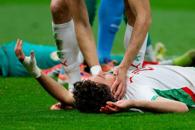 Morocco's midfielder #24 Neil El Aynaoui lies on the ground after being injured during the Africa Cup of Nations (CAN) final football match between Senegal and Morocco at the Prince Moulay Abdellah Stadium in Rabat on January 18, 2026. (Photo by Abdel Majid BZIOUAT / AFP)