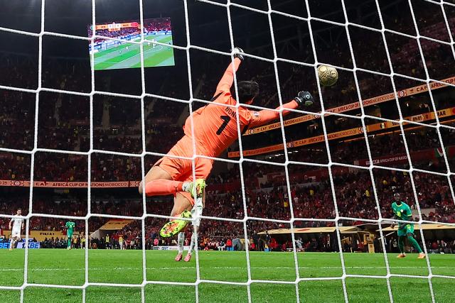Morocco's goalkeeper #01 Yassine Bounou saves an attempt during the Africa Cup of Nations (CAN) final football match between Senegal and Morocco at the Prince Moulay Abdellah Stadium in Rabat on January 18, 2026. (Photo by FRANCK FIFE / AFP)