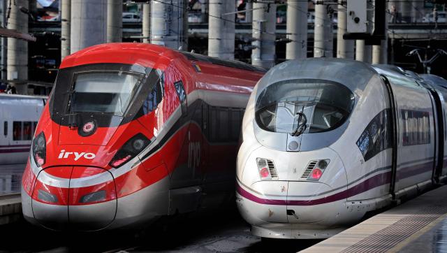 (FILES) High-speed train AVE of the Spanish national railways company RENFE (R) is seen next to high-speed train of private operator Iryo of ILSA company at the Atocha station in Madrid, on February 26, 2023. At least five people have been killed after a train derailed on January 18, 2026 in the southern Spanish province of Cordoba following a collision with another train, a police spokesman told AFP. (Photo by Thomas COEX / AFP)