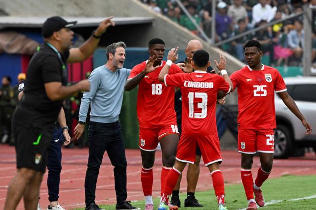 Panama's midfielder #18 Kadir Barria (C) celebrates with Danish coach Thomas Christiansen (L) and teammates after scoring his team's first goal during the international friendly football match between Bolivia and Panama at the IV Centenario Stadium in Tarija, Bolivia on January 18, 2026. (Photo by Aizar RALDES / AFP)