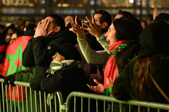 Supporters react as they watch the Africa Cup of Nations (CAN) final football match between Senegal and Morocco on a giant screen in front of the Arab Institute in Paris on January 18, 2026. (Photo by Martin LELIEVRE / AFP)