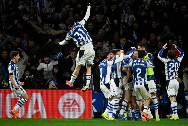 Real Sociedad's players celebrate their second goal scored by Portuguese forward #11 Goncalo Guedes during the Spanish league football match between Real Sociedad and FC Barcelona at Anoeta Stadium in San Sebastian on January 18, 2026. (Photo by ANDER GILLENEA / AFP)