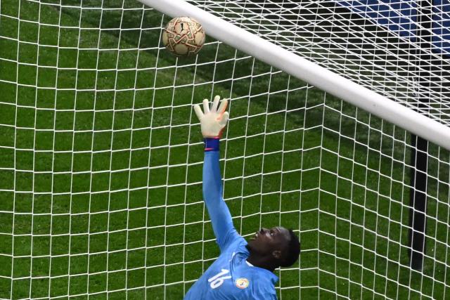 Senegal's goalkeeper #16 Edouard Mendy makes a save during the Africa Cup of Nations (CAN) final football match between Senegal and Morocco at the Prince Moulay Abdellah Stadium in Rabat on January 18, 2026. (Photo by Paul ELLIS / AFP)