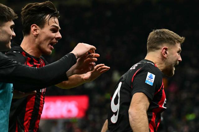 AC Milan's German forward #09 Niclas Fullkrug (R) celebrates scoring his team's first goal during the Italian Serie A football match between AC Milan and Lecce at San Siro stadium in Milan, northern Italy, on January 18, 2026. (Photo by Stefano RELLANDINI / AFP)