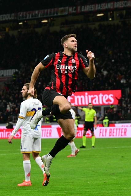 AC Milan's German forward #09 Niclas Fullkrug celebrates scoring his team's first goal during the Italian Serie A football match between AC Milan and Lecce at San Siro stadium in Milan, northern Italy, on January 18, 2026. (Photo by Stefano RELLANDINI / AFP)