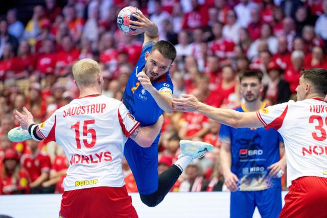 Denmark's pivot #15 Magnus Saugstrup (L) stops Romania's left wing #02 Denis Veres (2nd L) during the men's EHF Euro 2026 preliminary round group B handball match Romania vs Denmark in Herning, Denmark, on January 18, 2026. (Photo by Bo Amstrup / Ritzau Scanpix / AFP) / Denmark OUT