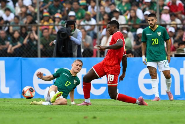 Bolivia's defender #17 Lucas Macazaga and Panama's midfielder #18 Kadir Barria fight for the ball during the international friendly football match between Bolivia and Panama at the IV Centenario Stadium in Tarija, Bolivia on January 18, 2026. (Photo by Aizar RALDES / AFP)