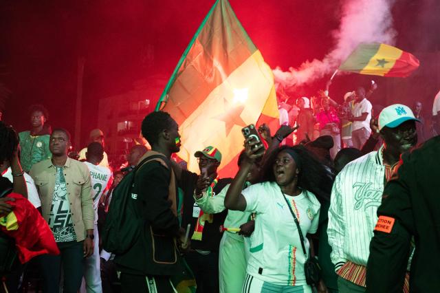 Senegal football supporters celebrate at a fan zone at the Obelisk Square in Dakar on January 18, 2026 after Senegal won the Africa Cup of Nations (CAN) final football match between Senegal and Morocco played in Rabat, Morocco. (Photo by SEYLLOU / AFP)