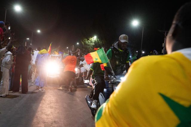Senegal football supporters celebrate at a fan zone at the Obelisk Square in Dakar on January 18, 2026 after Senegal won the Africa Cup of Nations (CAN) final football match between Senegal and Morocco played in Rabat, Morocco. (Photo by SEYLLOU / AFP)