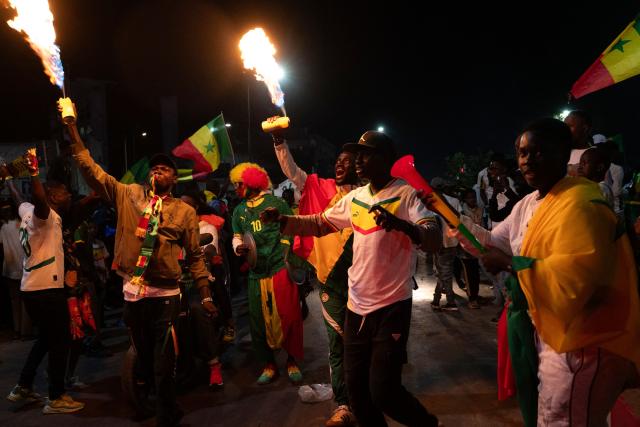 TOPSHOT - Senegal football supporters celebrate at a fan zone at the Obelisk Square in Dakar on January 18, 2026 after Senegal won the Africa Cup of Nations (CAN) final football match between Senegal and Morocco played in Rabat, Morocco. (Photo by SEYLLOU / AFP)