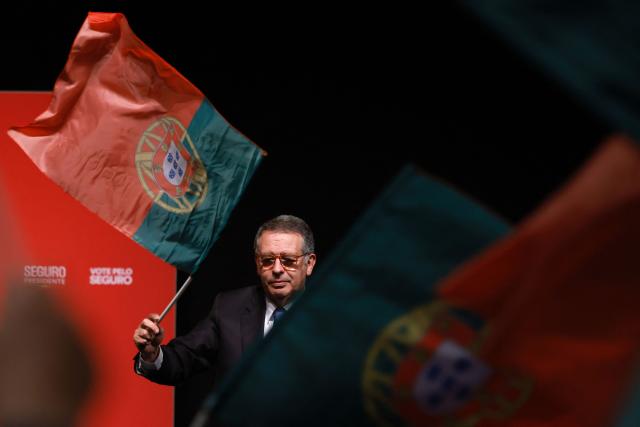 Socialist candidate Jose Antonio Seguro waves a Portuguese flag as he addresses supporters on the night of Portugal's presidential election first round in Caldas da Rainha on January 18, 2026. Portugal's socialist candidate won the first round of the presidential election and will face the far-right candidate in the second round, near-complete results showed today. With votes from 95 percent of constituencies counted, Socialist Antonio Jose Seguro was leading with 30.6 percent of the vote, while far-right contender Andre Ventura came in second with 24.2 percent. (Photo by PATRICIA DE MELO MOREIRA / AFP)