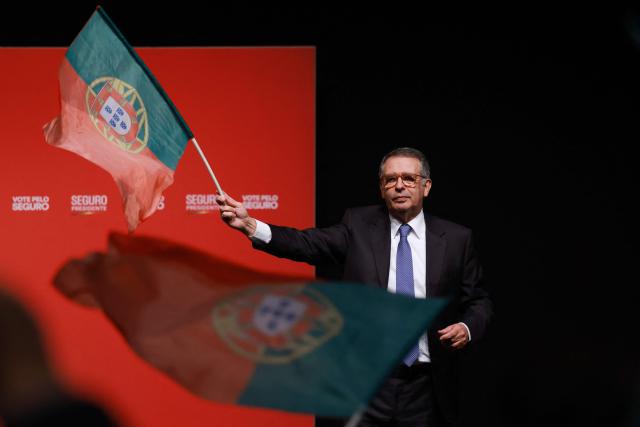 Socialist candidate Jose Antonio Seguro waves a Portuguese flag as he addresses supporters on the night of Portugal's presidential election first round in Caldas da Rainha on January 18, 2026. Portugal's socialist candidate won the first round of the presidential election and will face the far-right candidate in the second round, near-complete results showed today. With votes from 95 percent of constituencies counted, Socialist Antonio Jose Seguro was leading with 30.6 percent of the vote, while far-right contender Andre Ventura came in second with 24.2 percent. (Photo by PATRICIA DE MELO MOREIRA / AFP)