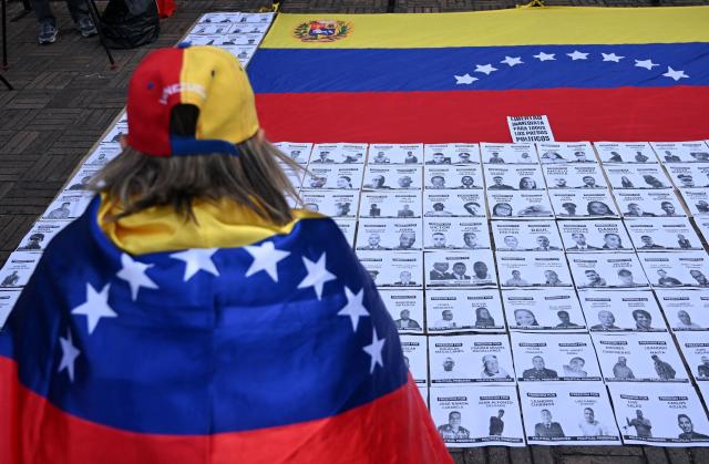 A woman takes part in a demonstration to demand the freedom of Venezuelan political prisoners at Bolivar square in Bogota on January 18, 2026. (Photo by Raul ARBOLEDA / AFP)