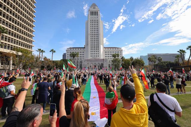 People participate in an anti-Iranian regime rally in Los Angeles, California on January 18, 2026. Protests in Iran have subsided after a crackdown killed thousands, monitors said, after the start of the largest demonstrations in years challenged the country's theocratic system. (Photo by Jonathan Alcorn / AFP)