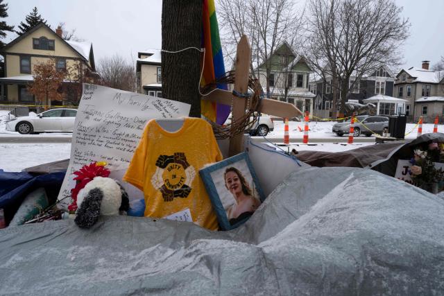 An image of Renee Nicole Good, who was fatally shot by a US Immigration and Customs Enforcement (ICE) officer in Minneapolis, is seen next to a makeshift memorial next to where her vehicle came to a stop after the incident in Minneapolis, Minnesota, on January 18, 2026. Renee Nicole Good, 37, was shot dead in her car by an Immigration and Customs Enforcement officer in Minneapolis on January 7 as the Trump administration pressed operations to catch undocumented migrants in the midwestern state of Minnesota. (Photo by ROBERTO SCHMIDT / AFP)