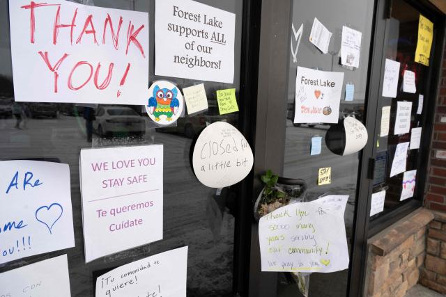 A sign on a Mexican restaurant in Forest Lake, Minnesota can be seen advising customers that they have temporarily closed on January 18, 2026 after US Immigration and Customs Enforcement (ICE) agents descended on the area. Well wishers have left good will messages at the front door of the restaurant in the small city near Minneapolis, Minnesota. (Photo by ROBERTO SCHMIDT / AFP)