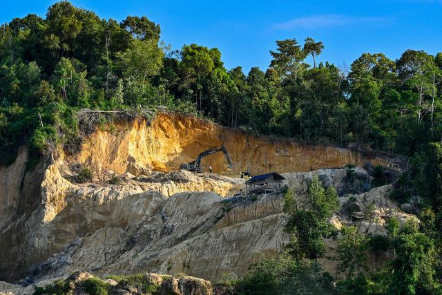 An excavator works at a sand quarry in Lamno, Indonesia's Aceh province on January 18, 2026. (Photo by CHAIDEER MAHYUDDIN / AFP)
