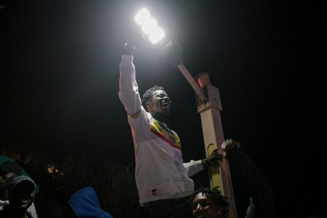 A Senegal supporter reacts at the African Renaissance Monument in Dakar on January 18, 2026 as supporters gather at a fan zone to watch the Africa Cup of Nations (CAN) final football match between Senegal and Morocco played in Rabat, Morocco. (Photo by Carmen Abd Ali / AFP)
