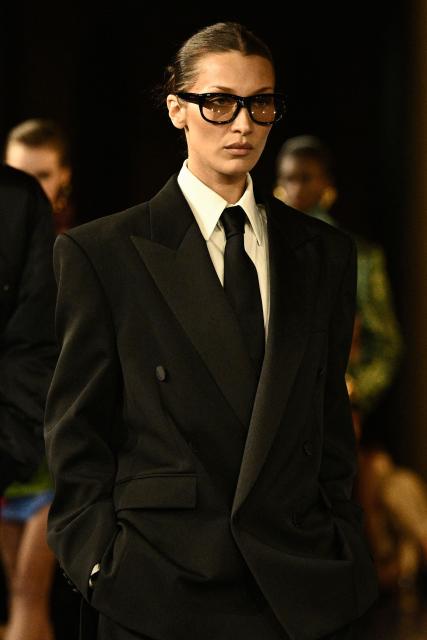 (FILES) American super model Bella Hadid presents a creation by Saint Laurent for the Women Ready-to-wear Spring-Summer 2025 collection as part of the Paris Fashion Week, in Paris on September 24, 2024. Nicole Kidman, Demi Moore, Bella Hadid... Actresses and models are unapologetically sporting ties, the quintessential male accessory, in a gesture that is gaining momentum at a time when women's rights are faltering in some countries. This long-standing male garment, so closely associated in our time with men in suits and the professional world, but which the pandemic left somewhat in the wardrobe, is once again being seen in women's looks. (Photo by JULIEN DE ROSA / AFP)