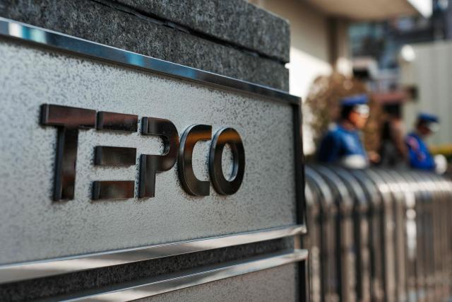 The logo of Tokyo Electric Power Company is seen at an entrance to the company's headquarters in Tokyo on January 19, 2026. (Photo by Kazuhiro NOGI / AFP)