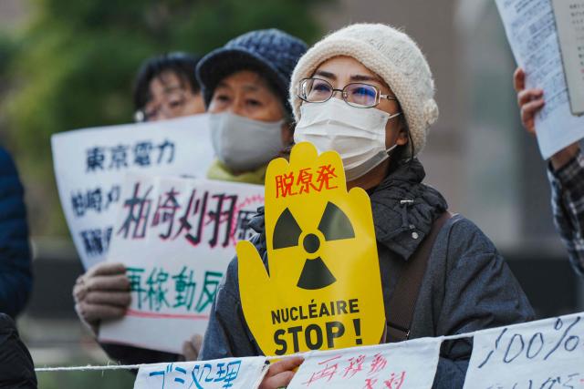 Participants demonstrate in front of Tokyo Electric Power Company's headquarters, against the restart of the Kashiwazaki-Kariwa Nuclear Power Plant, in Tokyo on January 19, 2026. (Photo by Kazuhiro NOGI / AFP)