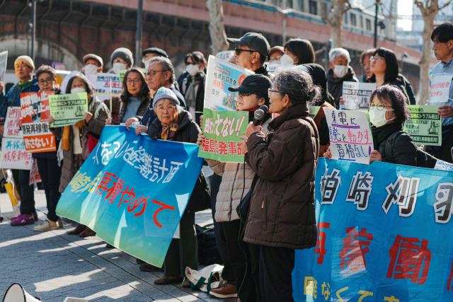 Participants demonstrate in front of Tokyo Electric Power Company's headquarters, against the restart of the Kashiwazaki-Kariwa Nuclear Power Plant, in Tokyo on January 19, 2026. (Photo by Kazuhiro NOGI / AFP)