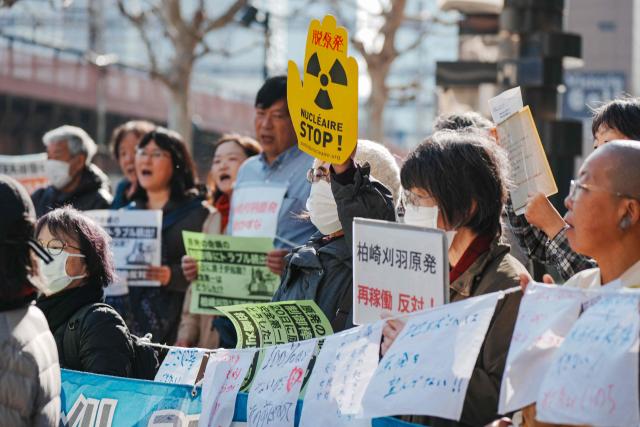 Participants demonstrate in front of Tokyo Electric Power Company's headquarters, against the restart of the Kashiwazaki-Kariwa Nuclear Power Plant, in Tokyo on January 19, 2026. (Photo by Kazuhiro NOGI / AFP)