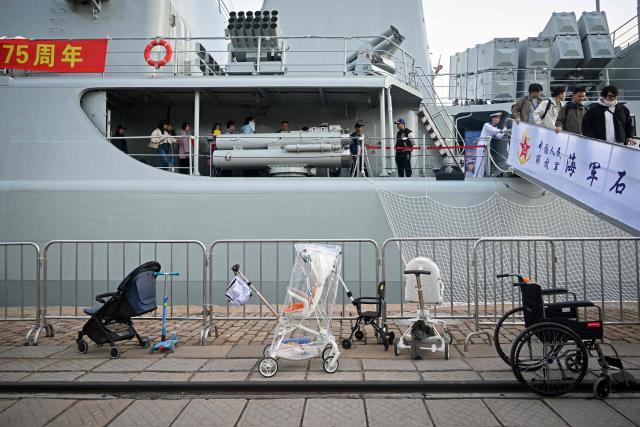 (FILES) People leave their baby carriages and a wheelchair on the dock as they visit Chinese Navy Shijianzhuang destroyer during a media tour organised by Chinese Navy at a port in Qingdao, China's Shandong province on April 20, 2024. China's birth rate fell last year to its lowest level on record, official data showed on January 19, 2026, as its population shrank for a fourth year running despite authorities' efforts to curb the decline. (Photo by WANG Zhao / AFP)