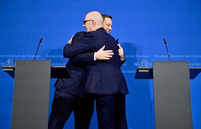 German Finance Minister and Vice Chancellor Lars Klingbeil (L) and French Minister of the Economy, Finance, and Industrial, Energy, and Digital Sovereignty Roland Lescure hug after giving a statement on January 19, 2026 in Berlin. (Photo by John MACDOUGALL / AFP)