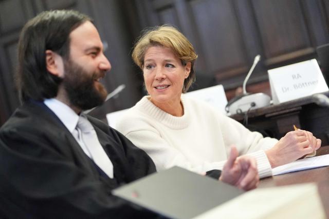 Defendant German entrepreneur and gastronome Christina Block (R) is seen next to her lawyer Ingo Bott as she waits for the continuation her trial over alleged child abduction at the District Court in Hamburg, northern Germany, on January 19, 2026. The public prosecutor's office accuses Block, heiress of a steakhouse chain, of ordering the abduction of her daughter, born in 2010, and her son, born in 2013. According to the indictment, the background to this is an escalating custody dispute over many years between Block and her former husband, who have four children together. (Photo by Marcus Brandt / POOL / AFP)
