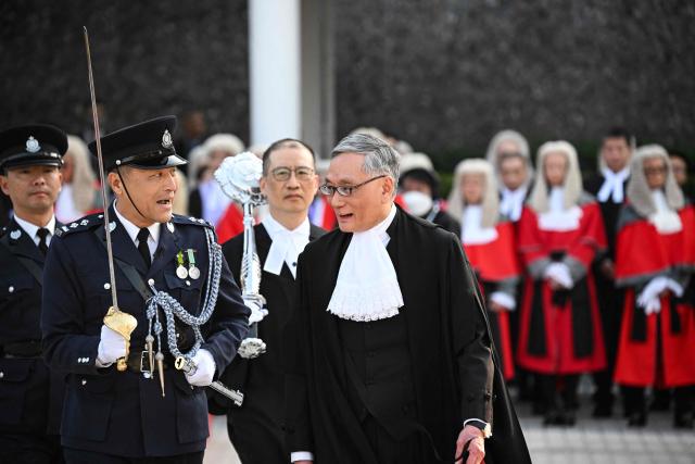 Hong Kong Chief Justice Andrew Cheung (C) inspects a guard of honour during a ceremony held to mark the opening of the legal year in Hong Kong on January 19, 2026. (Photo by Peter PARKS / AFP)