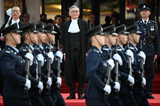Hong Kong Chief Justice Andrew Cheung (C) inspects a guard of honour during a ceremony held to mark the opening of the legal year in Hong Kong on January 19, 2026. (Photo by Peter PARKS / AFP)