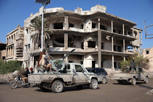 Syrian government forces deploy in Deir Ezzor, eastern Syria on January 19, 2026, the day after an agreement between the Syrian government and the Kurdish forces. In Deir Ezzor, an AFP correspondent saw dozens of military vehicles heading to the east of the Euphrates river, which once separated Damascus-controlled areas to the west from the US-backed, Kurdish-led Syrian Democratic Forces (SDF) to the east. After two days of rapid gains in Kurdish-controlled territory, the Syrian President announced on Januray 18, a deal with the Kurdish SDF leader that includes a ceasefire and the integration of the Kurdish administration and forces into the central state. (Photo by OMAR HAJ KADOUR / AFP)