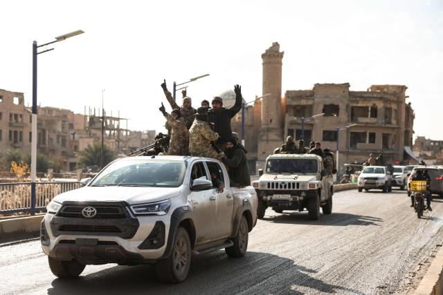 Syrian government forces deploy in Deir Ezzor, eastern Syria on January 19, 2026, the day after an agreement between the Syrian government and the Kurdish forces. In Deir Ezzor, an AFP correspondent saw dozens of military vehicles heading to the east of the Euphrates river, which once separated Damascus-controlled areas to the west from the US-backed, Kurdish-led Syrian Democratic Forces (SDF) to the east. After two days of rapid gains in Kurdish-controlled territory, the Syrian President announced on Januray 18, a deal with the Kurdish SDF leader that includes a ceasefire and the integration of the Kurdish administration and forces into the central state. (Photo by OMAR HAJ KADOUR / AFP)