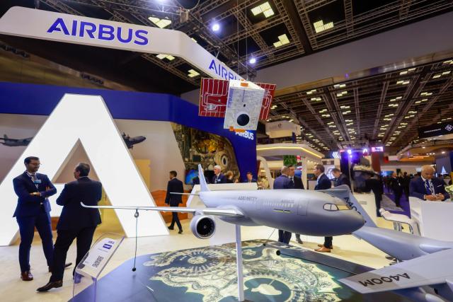 Visitors stand at the Airbus Pavilion during the Doha International Maritime Defence Exhibition and Conference (DIMDEX 2026) which showcases technology, maritime, and defence capabilities, at the Qatar National Convention Centre, in Doha on January 19, 2026. (Photo by Karim JAAFAR / AFP)