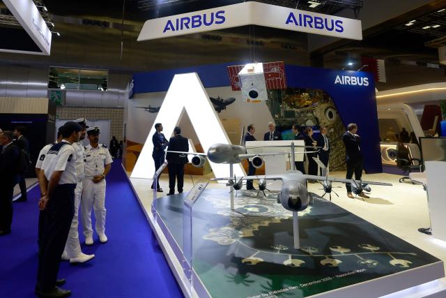 Visitors stand at the Airbus Pavilion during the Doha International Maritime Defence Exhibition and Conference (DIMDEX 2026) which showcases technology, maritime, and defence capabilities, at the Qatar National Convention Centre, in Doha on January 19, 2026. (Photo by Karim JAAFAR / AFP)
