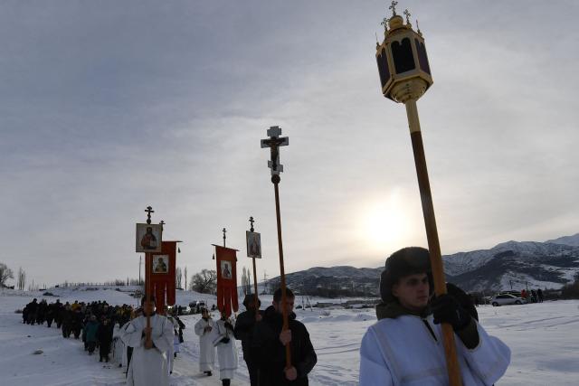 Orthodox believers attend a religious procession during the Epiphany holiday near the village of Sosnovka, northern Kyrgyzstan on January 19, 2026. (Photo by Vyacheslav OSELEDKO / AFP)