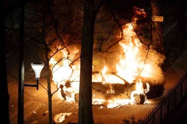A photo shows a car on fire following incidents during celebrations after the Africa Cup of Nations (CAN) football final, in the 18th arrondissement of Paris on January 19, 2026. (Photo by JOEL SAGET / AFP)