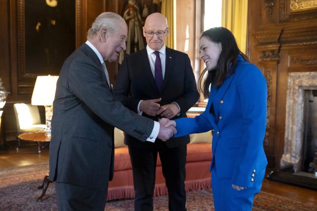 King Charles Britain's King Charles III (L) shakes hands with and Deputy First Minister Kate Forbes (R) as the First Minister of Scotland John Swinney (C) looks on during a reception at the Palace of Holyroodhouse, Edinburgh, on January 19, 2026, to mark the Scotland Investment Forum. (Photo by Jane Barlow / POOL / AFP)
