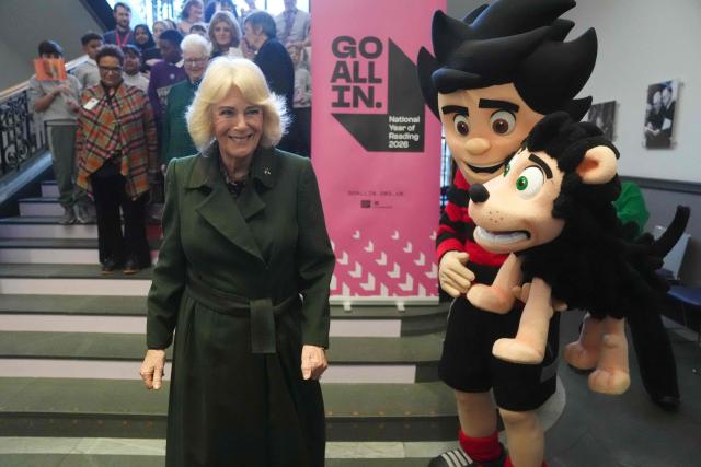 Britain's Queen Camilla meets Dennis the Menace and Gnasher during a visit to The National Library of Scotland in Edinburgh on January 19, 2026, to mark the launch of the National Year of Reading in Scotland, led by the Department for Education and the National Literacy Trust. (Photo by Andrew Milligan / POOL / AFP)