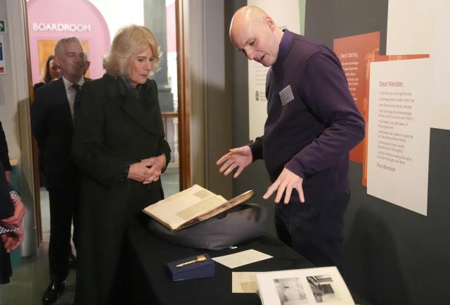 Britain's Queen Camilla is shown artefacts by Ralph McLean, including a ceremonal key used to open the building in 1956 during a visit to The National Library of Scotland in Edinburgh on January 19, 2026, to mark the launch of the National Year of Reading in Scotland, led by the Department for Education and the National Literacy Trust. (Photo by Andrew Milligan / POOL / AFP)
