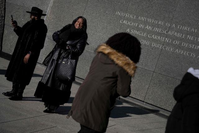 People leave after a celebration of Martin Luther King Jr. Day at the Martin Luther King, Jr. Memorial on the National Mall on January 19, 2026, in Washington, DC. (Photo by Brendan Smialowski / AFP)