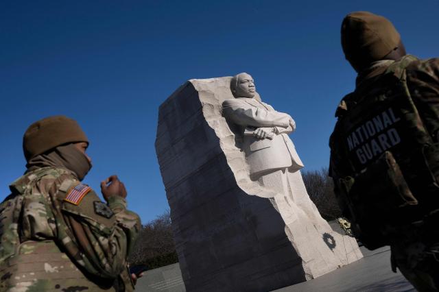 Members of the National Guard walk past the Martin Luther King, Jr. Memorial on the National Mall during Martin Luther King Jr. Day on January 19, 2026 in Washington, DC. (Photo by Brendan Smialowski / AFP)