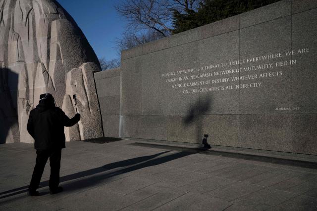 A person visits the Martin Luther King, Jr. Memorial on the National Mall during Martin Luther King Jr. Day on January 19, 2026 in Washington, DC. (Photo by Brendan Smialowski / AFP)