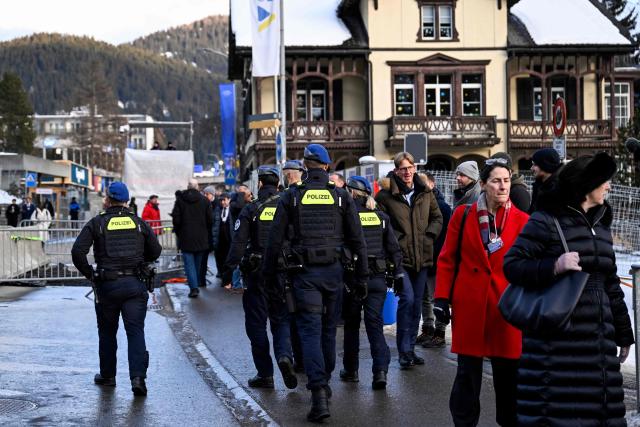 Police officers patrol in the Alpine resort of Davos during the World Economic Forum (WEF) annual meeting in Davos on January 19, 2026. The World Economic Forum takes place in Davos from January 19 to January 23, 2026. (Photo by INA FASSBENDER / AFP)
